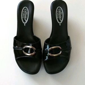 Black patient leather sandals.